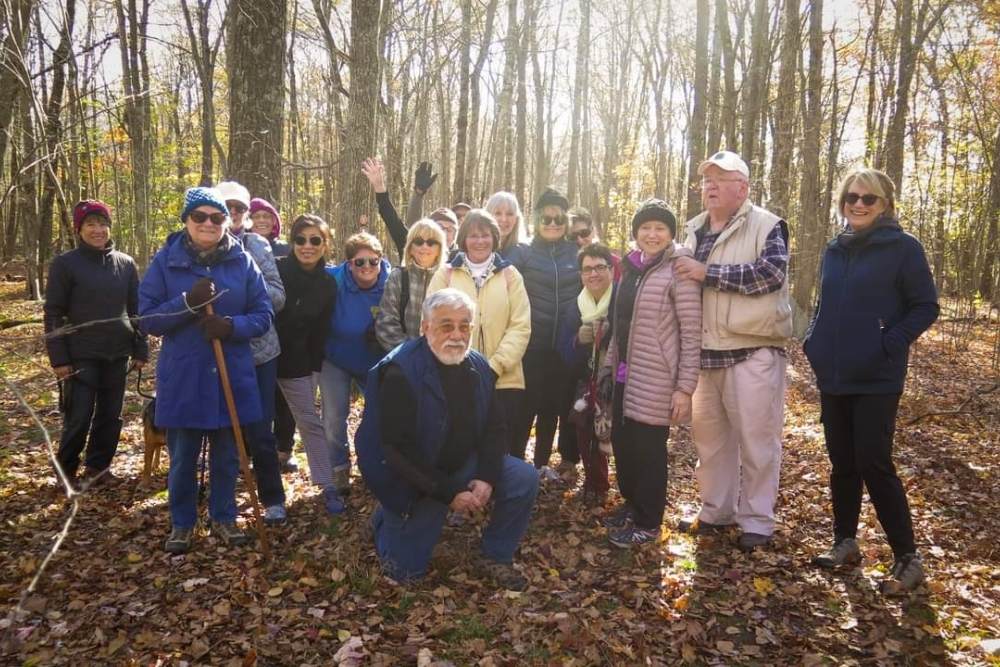 A group of people posting during a hike in the woods