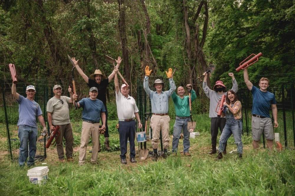 Group of people waving in the woods