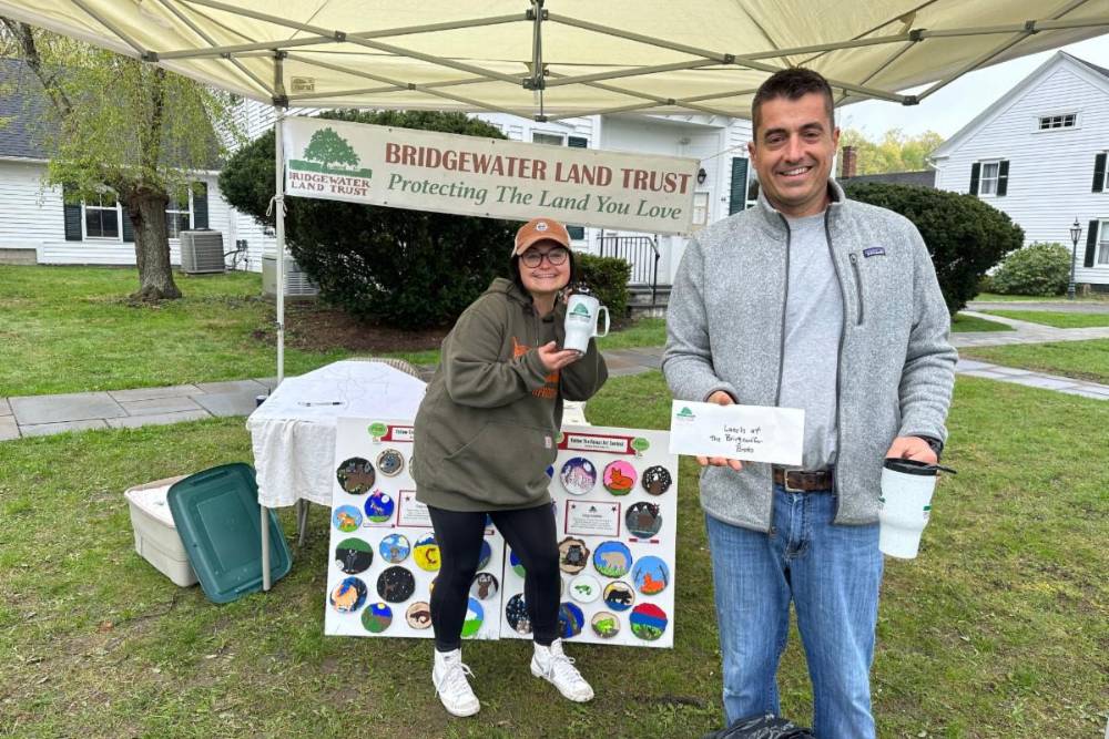 Posing at the Earth Day cleanup in front of the Bridgewater Land Trust sign