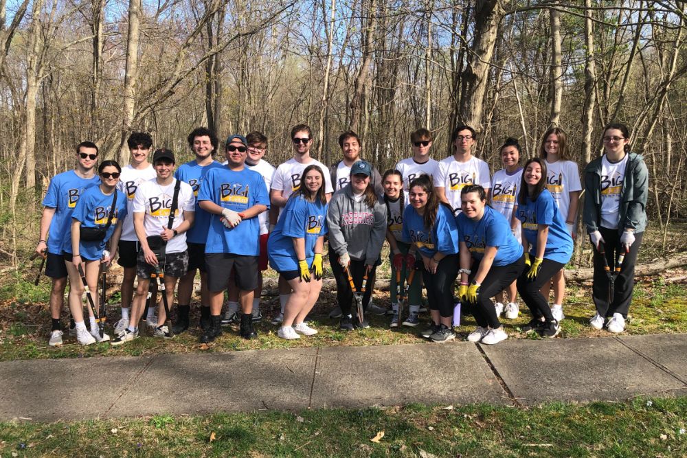 Group of students posing for a picture after cleaning up a trail