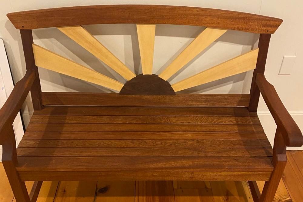 Wooden bench with sunbeam rays on the back of the bench