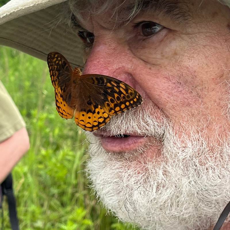 Close up of Victor with a butterfly on his nose