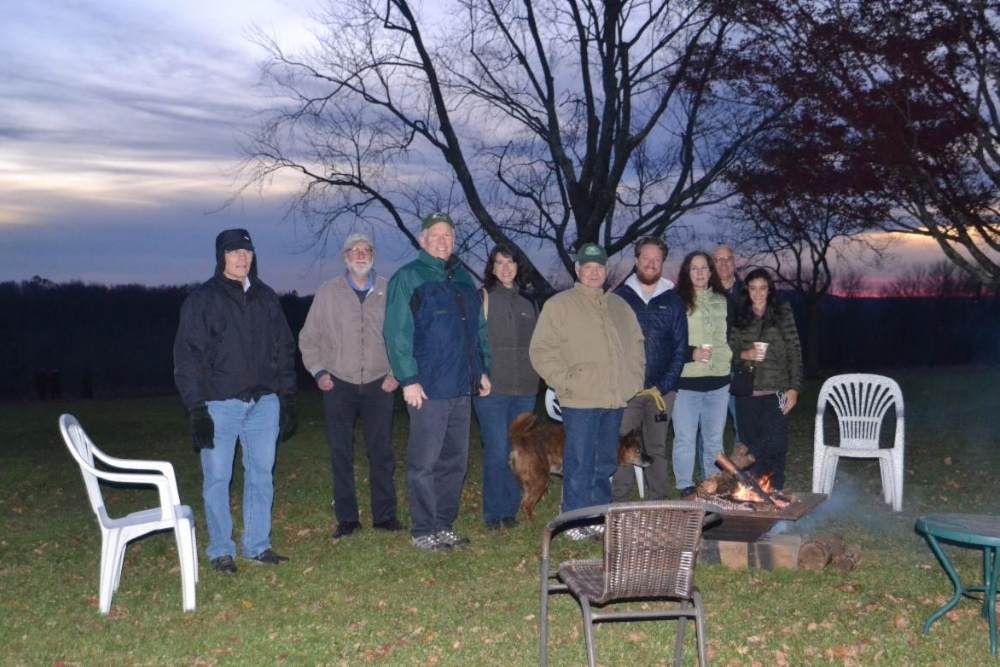 Group of people in the evening with an outdoor fire